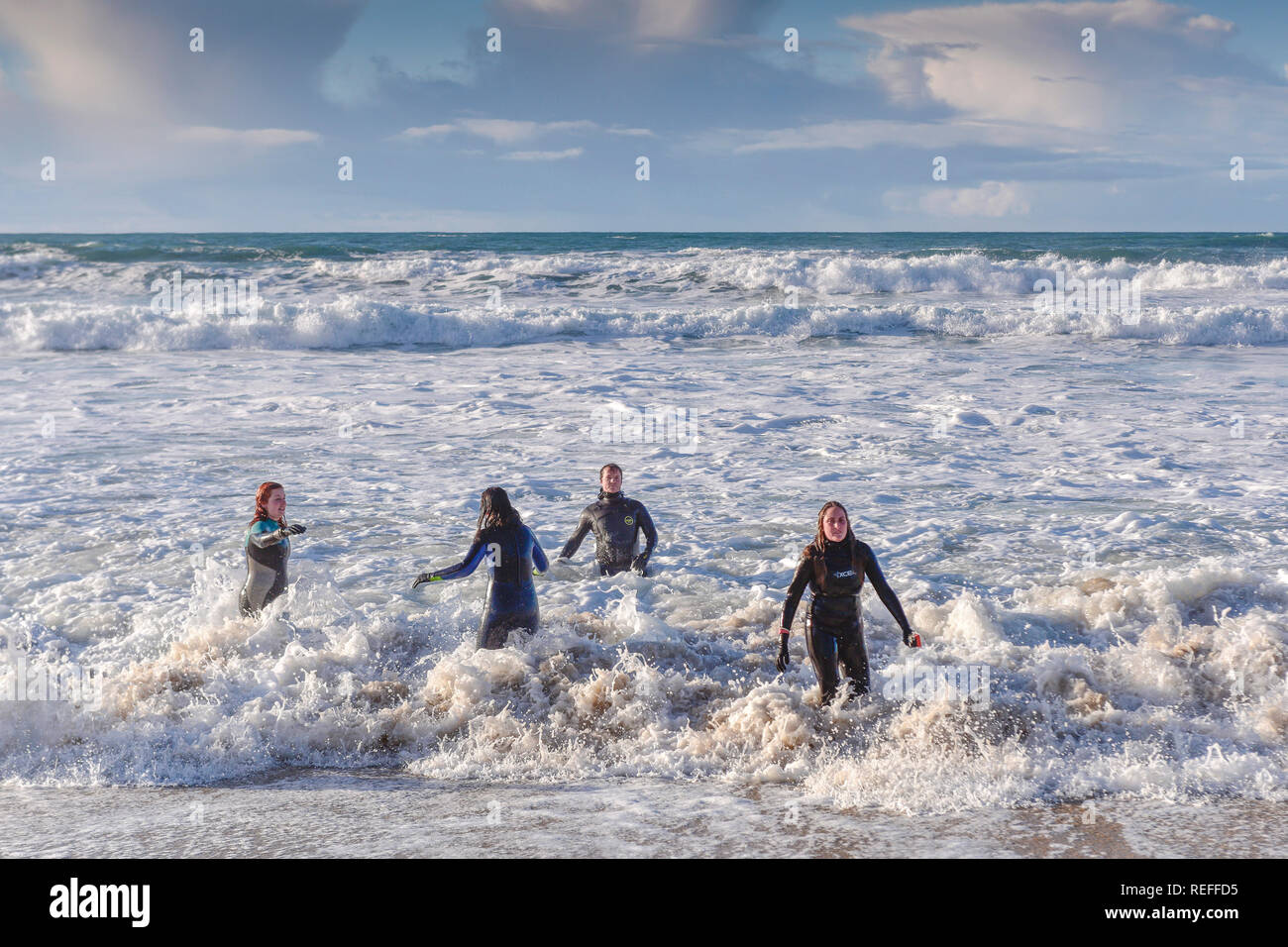People in wetsuits in the sea at Fistral Beach in Newquay Cornwall. Stock Photo