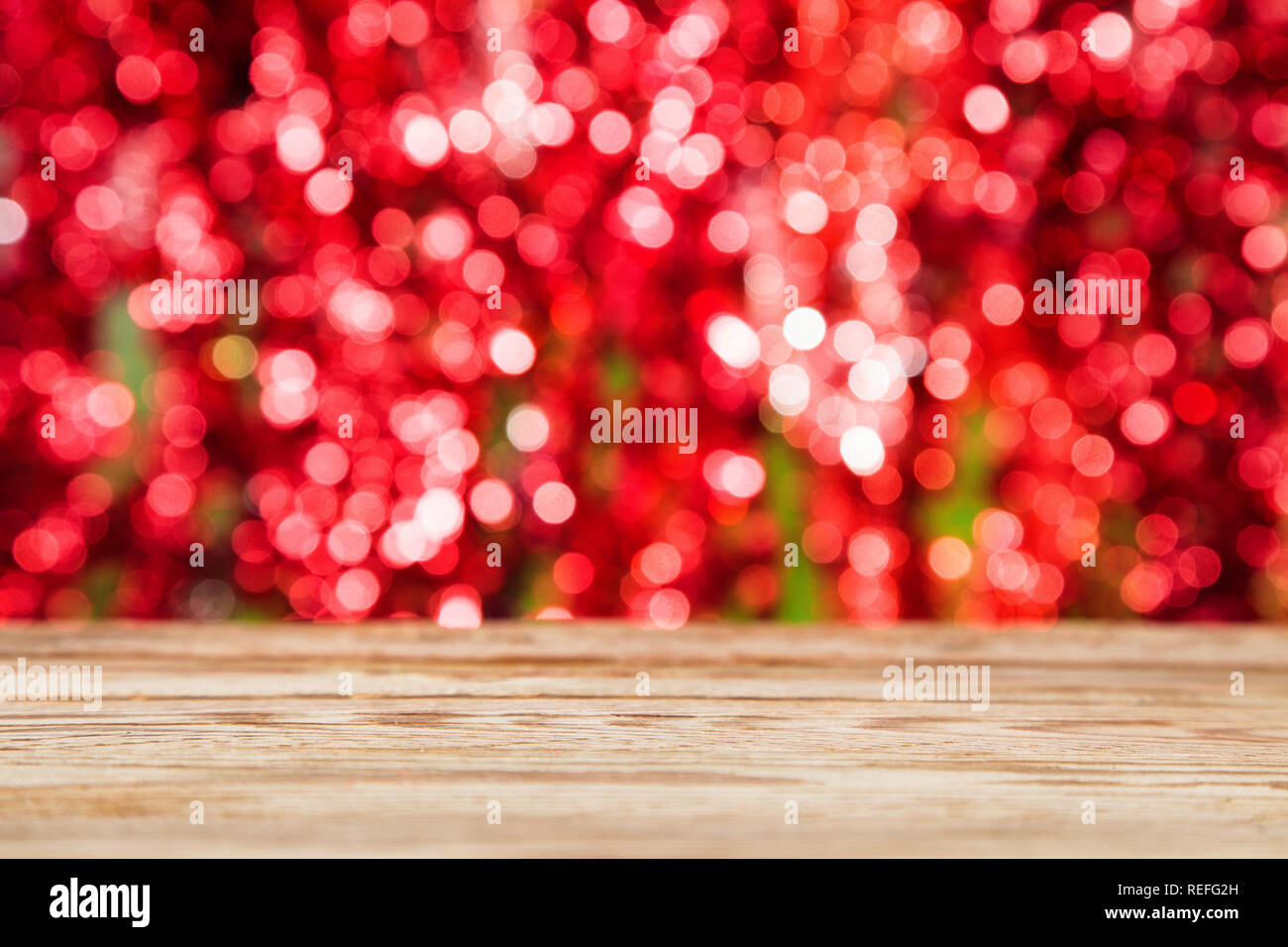 Empty wooden table over festive bokeh background. Christmas, Wedding, Valentines day holiday concept. Stock Photo