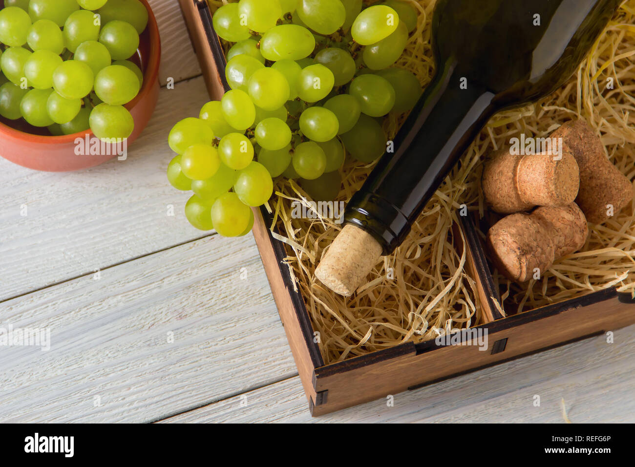 wine bottle, corks, grapes in wooden box. top view Stock Photo