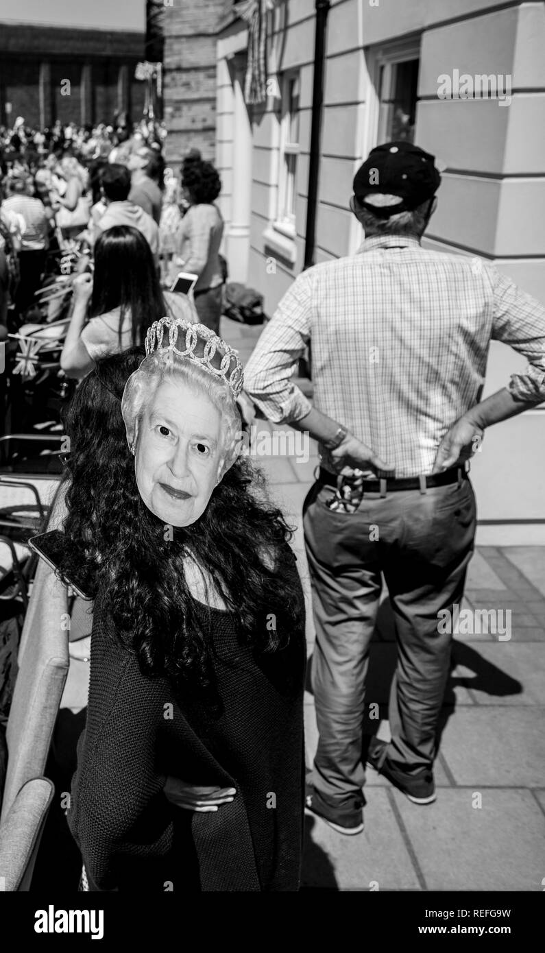 WINDSOR, BERKSHIRE, UNITED KINGDOM - MAY 19, 2018: Woman wearing Queen Elisabeth II mask at royal wedding marriage celebration of Prince Harry, Duke of Sussex and the Duchess of Sussex Meghan Markle Stock Photo