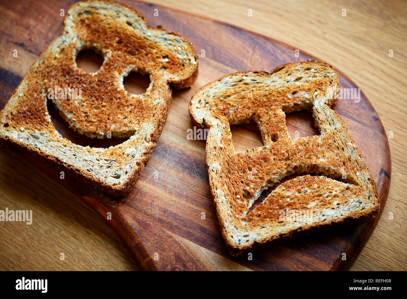 Slice of brown toast on chopping board Stock Photo
