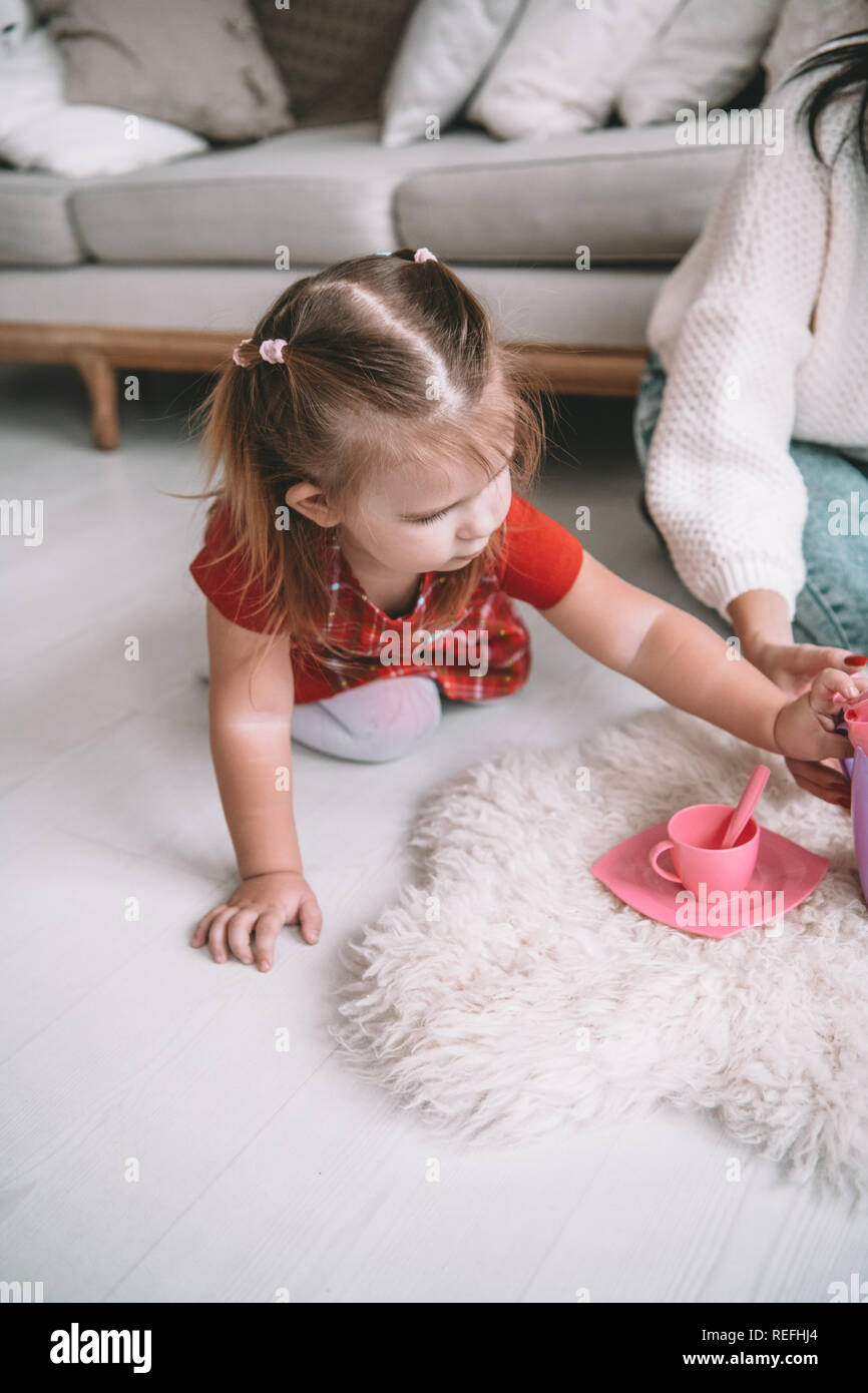 little girl play dishes