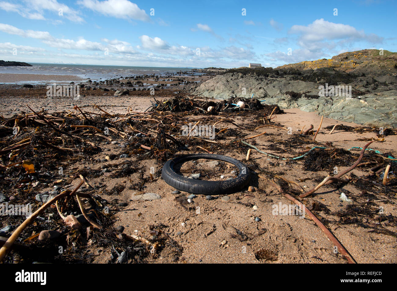 Beach debris rubber tyres and ropes washed up on a beach in Elie Fife Scotland Stock Photo