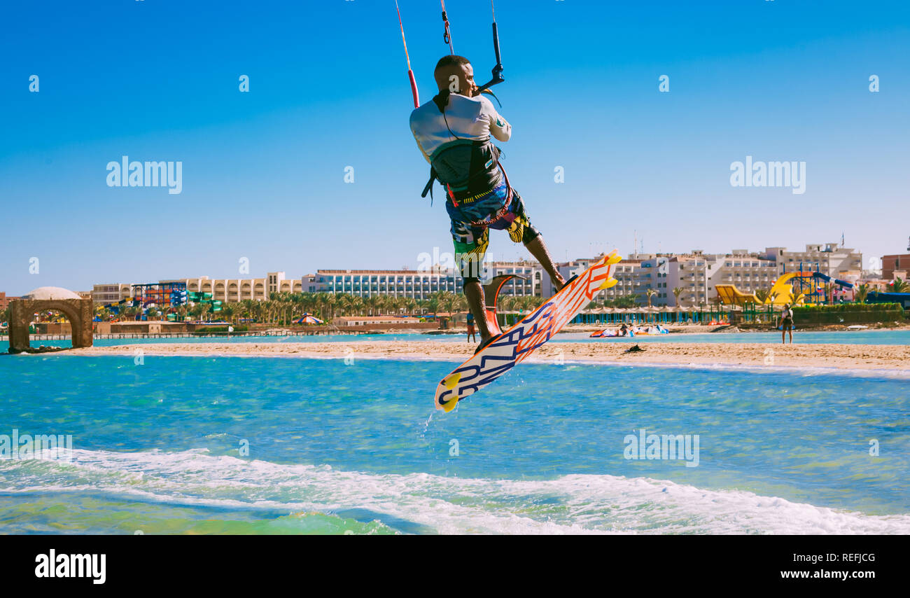 Egypt, Hurghada - 30 November, 2017: The kitesurfer soaring over the Red sea waves. Extreme water sport activity. The Panorama Bungalows Aqua Park Hot Stock Photo