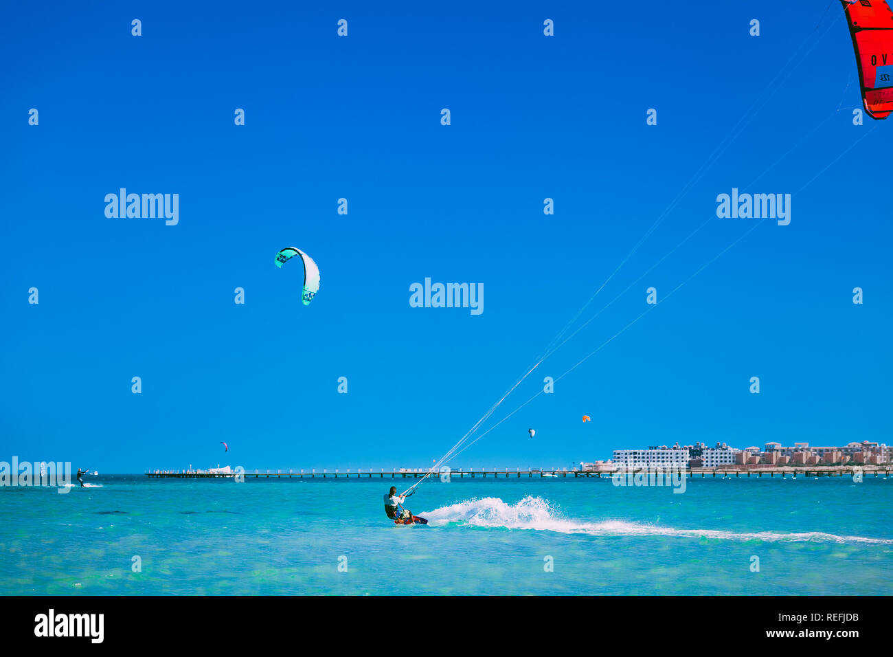 Egypt, Hurghada - 30 November, 2017: The kiters gliding over the Red sea surface. The popular professional and tourist attraction. The Panorama Bungal Stock Photo