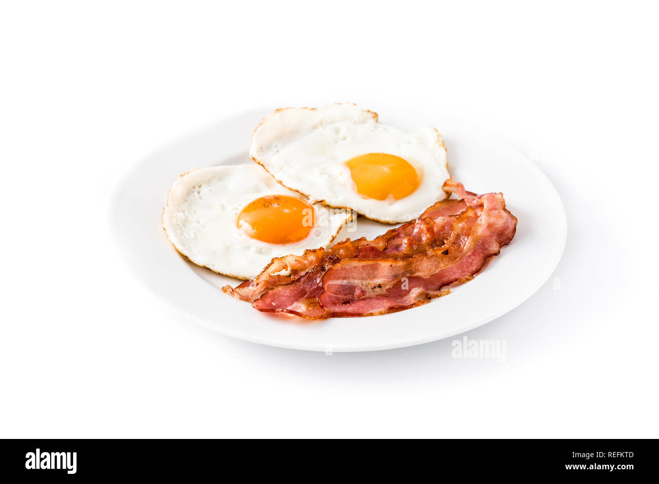 Fried eggs and bacon for breakfast isolated on white background. Stock Photo