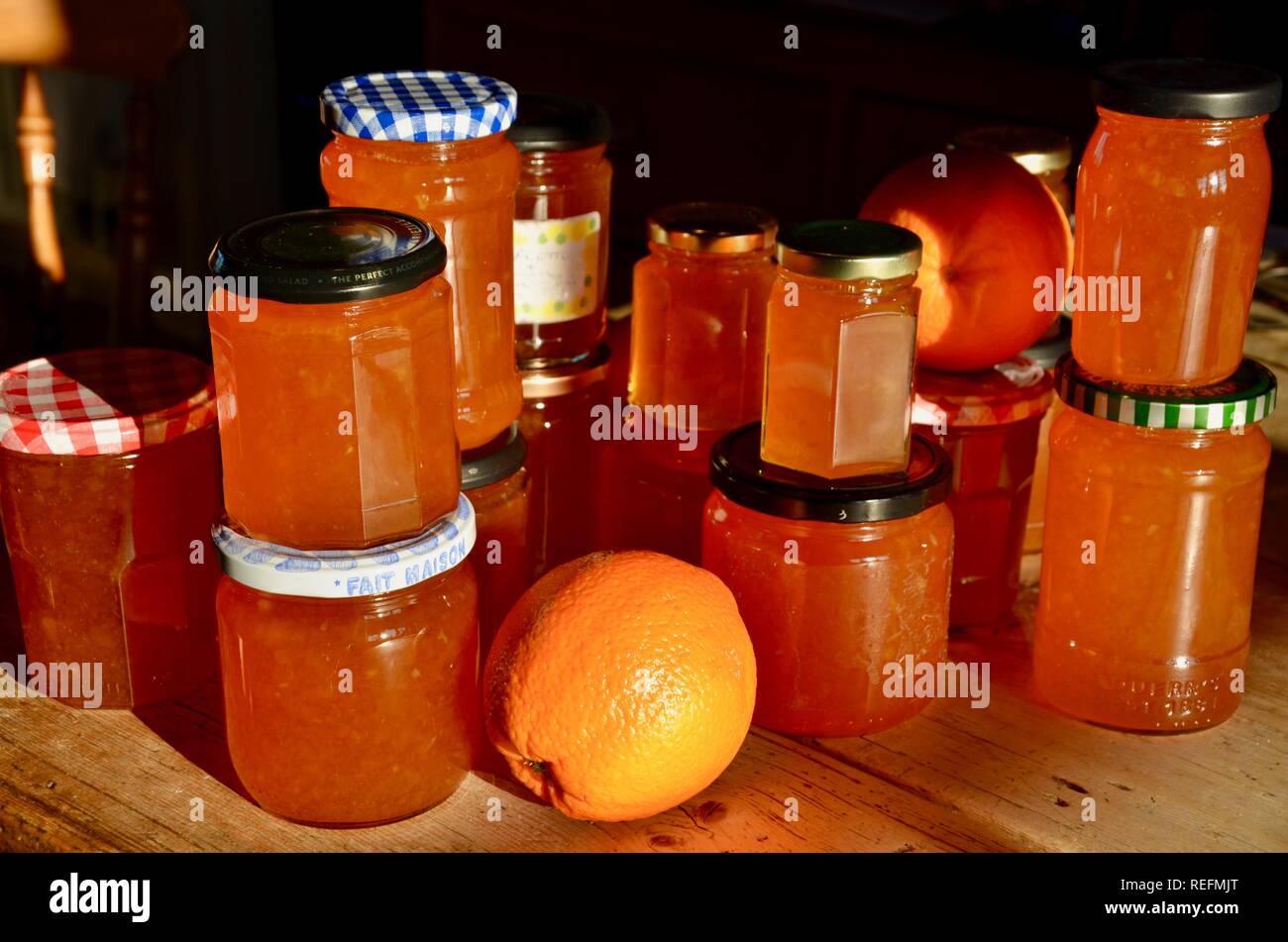 Home made Seville orange marmalade in jars on wooden table Stock Photo