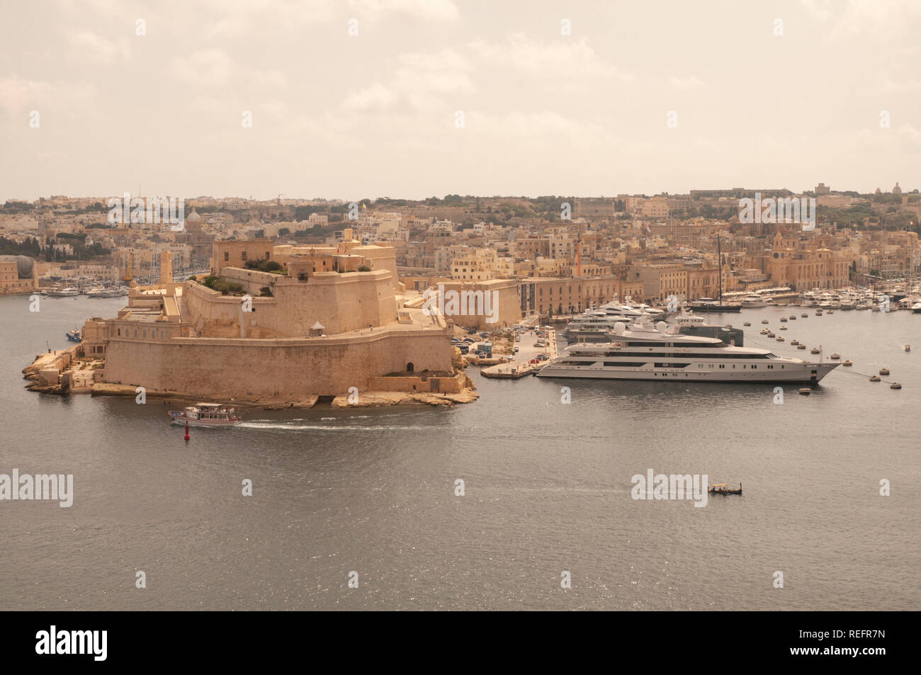 View over the Grand Harbour and Fort St. Angelo with Vittoriosa Yacht Marina from Upper Barrakka Gardens in Valletta, Malta. Stock Photo
