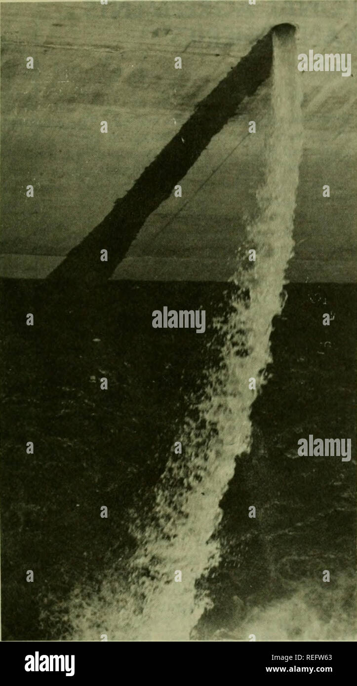 . Commercial fisheries review. Fisheries; Fish trade. 29. Fig. 2 - Experimental submerged port (6-inch diameter) in- stalled at McNary Dam by the U.S. Army Corps of Engineers. It passes fingerlings from one of the 44 intake gatewells into the ice sluice for transport around the turbines. sections of the dam. Future research must determine where fish should be released in the tailrace to minimize predation, whether predation is reduced when fish are released only at night, and whether the spilling of wa- ter through a spillway gate near the release site reduces predation. From these and sim- il Stock Photo