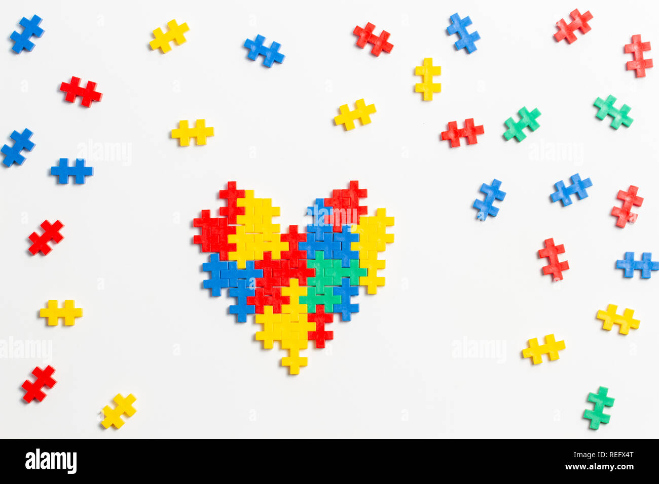 Top view on heart made of colorful plastic construction bricks on white background Stock Photo