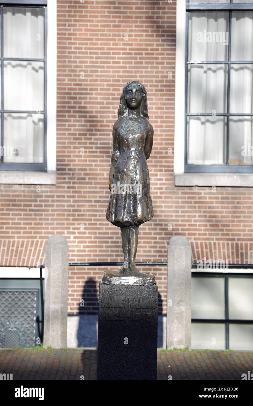 The bronze sculpture of Anne Frank standing on the Westermarkt in Amsterdam near the Anne Frank House. It was created by Mari S. Andriessen. Stock Photo