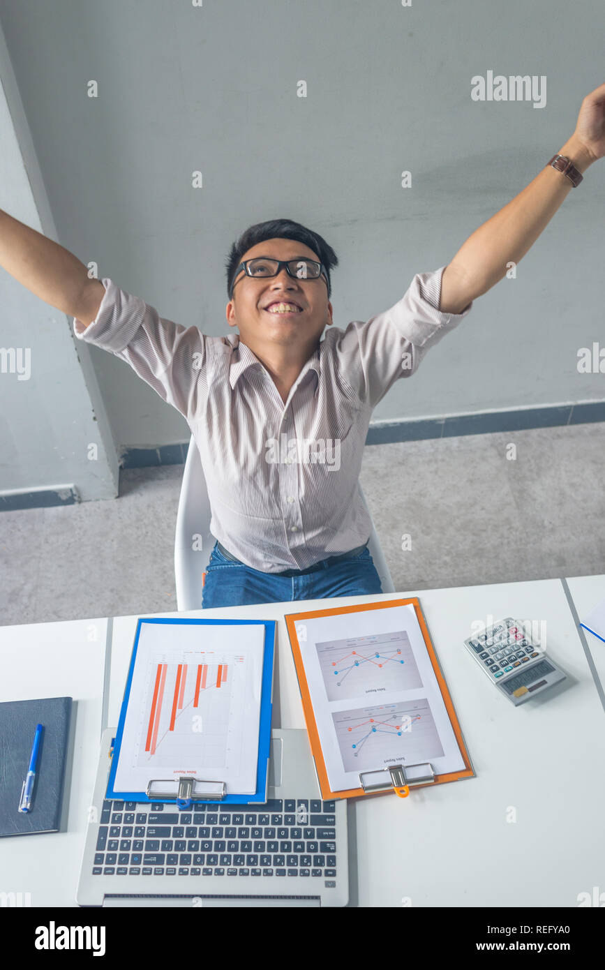 Happy businessman raising his arms, celebrate the success in the ...