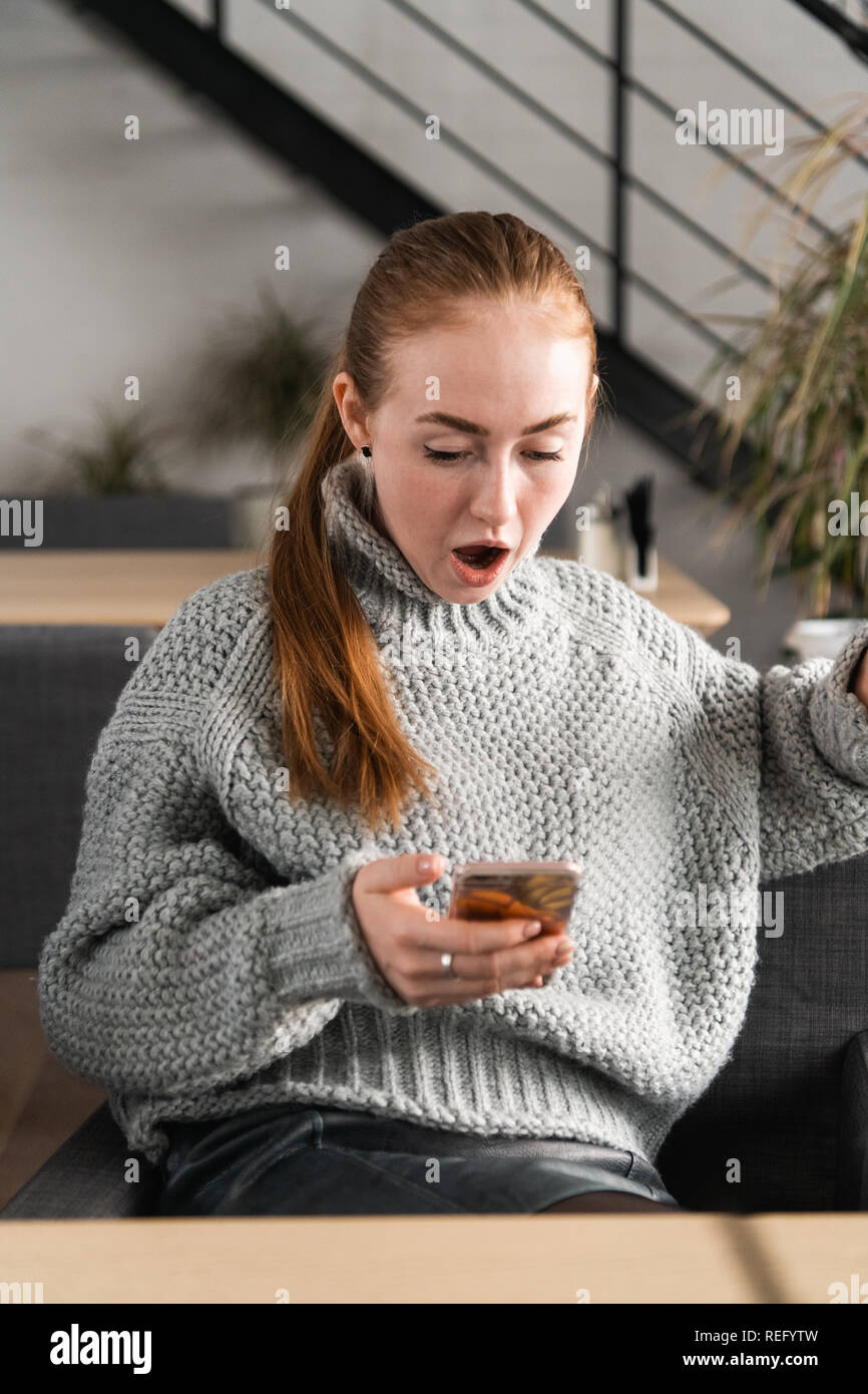 SMS. Closeup portrait funny shocked anxious scared young girl looking at  phone seeing bad news photos message with disgusting emotion on face. Human  reaction, expression Stock Photo - Alamy