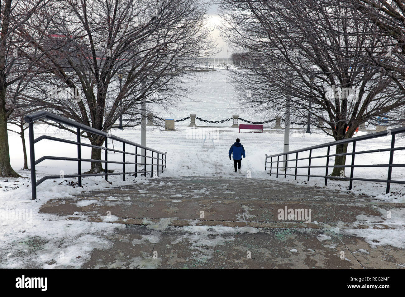 Cleveland, Ohio, USA, 21st January 2019.  A solitary man braves the extreme cold weather that has followed winter storm Harper.  The Northcoast Harbor off the shores of Lake Erie is frozen over, the first time this winter season.  Credit: Mark Kanning/Alamy Live News. Stock Photo
