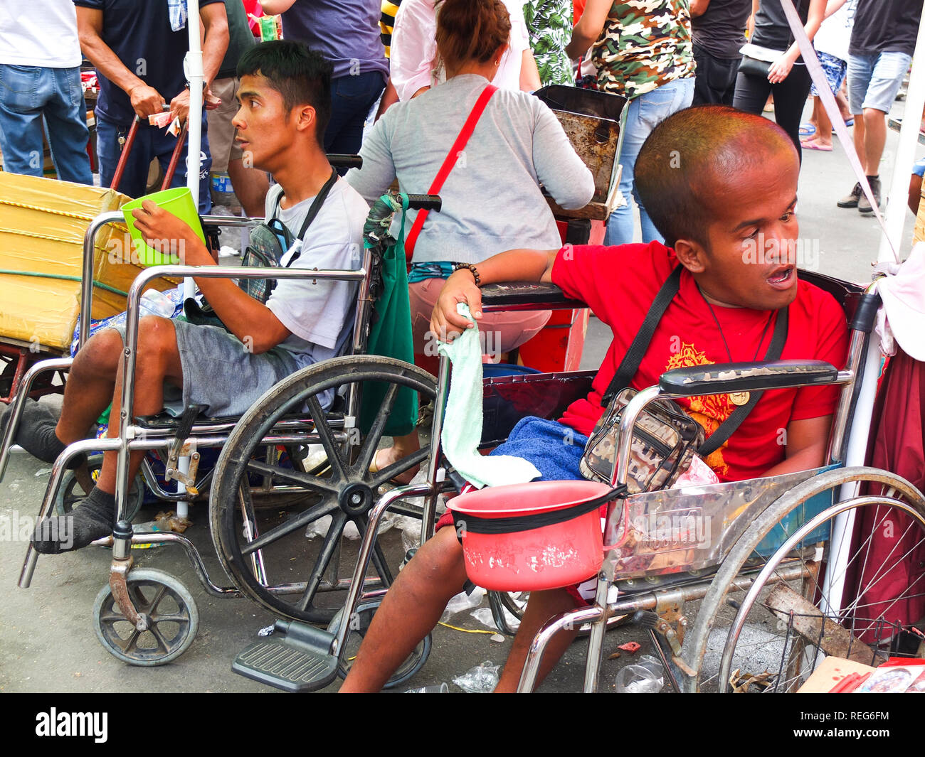 Persons with disabilities asking for alms were seen outside the Tondo Church during the Feast of the Sto. Niños in Tondo. Catholic Devotees bring their Sto. Niños to be blessed by holy water by the parish priest of Tondo church to celebrate the Feast of the Santo Niño (Child Jesus). Stock Photo