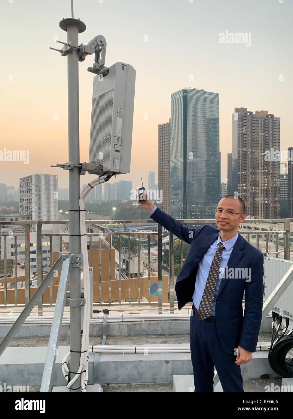 Shenzhen, China. 21st Jan, 2019. An employee of the Chinese mobile operator China Telecom shows a Huawei base station for the new 5G network standing on the roof of a high-rise building in the Nanshan district. In Shenzhen, where Huawei is also headquartered, there are already several hundred 5G stations. China is pushing ahead massively with the expansion of the new mobile communications standard, which transports data faster and in much larger volumes. Credit: Andreas Landwehr/dpa/Alamy Live News Stock Photo