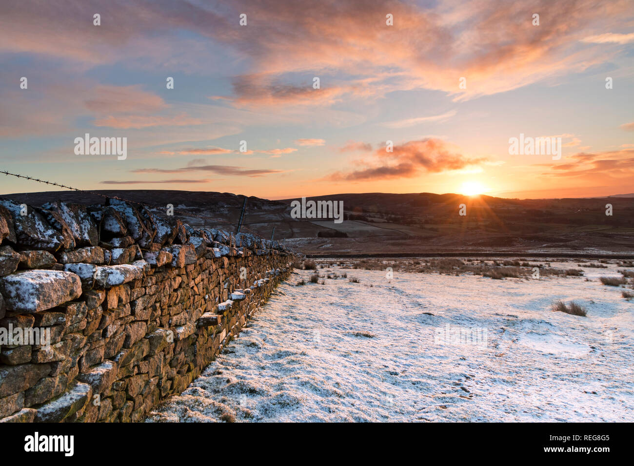 Teesdale, County Durham, UK.  Tuesday 22nd January 2019. UK Weather.  It was a cold, snowy but colourful start to the day as the sun rose over the North Pennines in County Durham. The forecast is for sunny spells and further snow showers, some of which could be heavy. Credit: David Forster/Alamy Live News Stock Photo