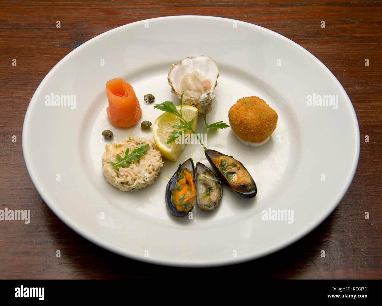 A starter of smoked salmon, oyster, crab croquette, mussels and mackerel pate Stock Photo Alamy