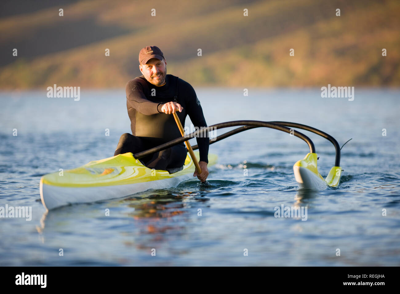 Portrait of a smiling man paddling in a kayak on a river. Stock Photo