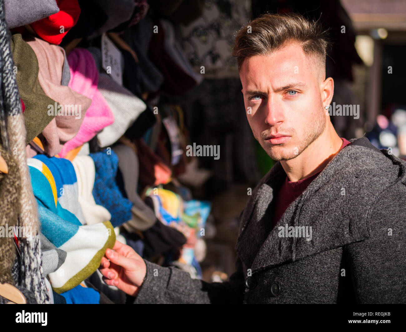 Young man browsing through products in open air market Stock Photo