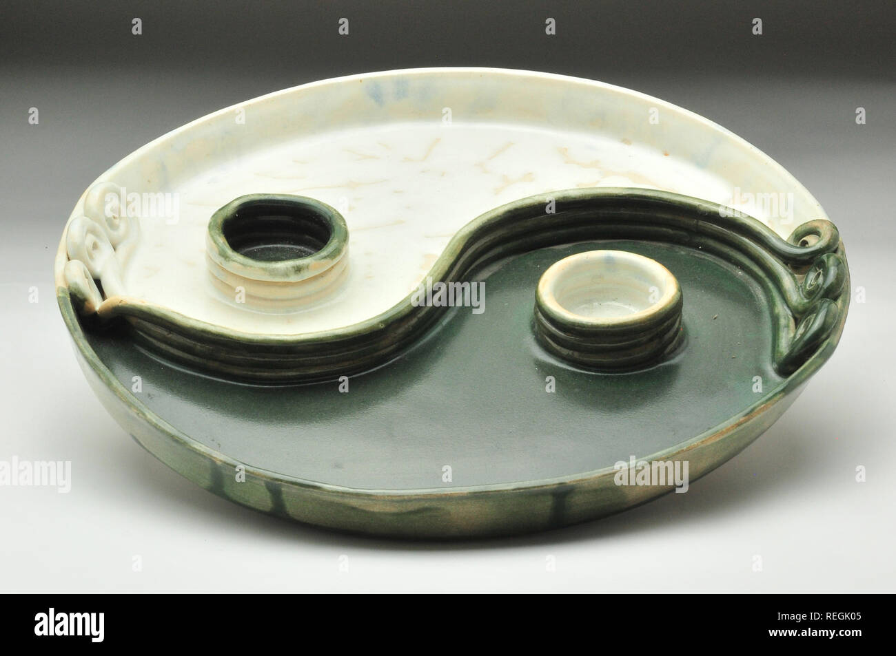 Green and white Yin yang tealight ceramic glazed platter Stock Photo