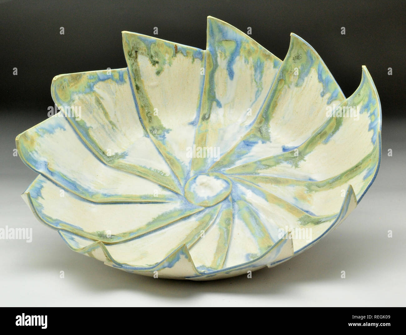 Green blue and white petal formed ceramic glazed dish Stock Photo