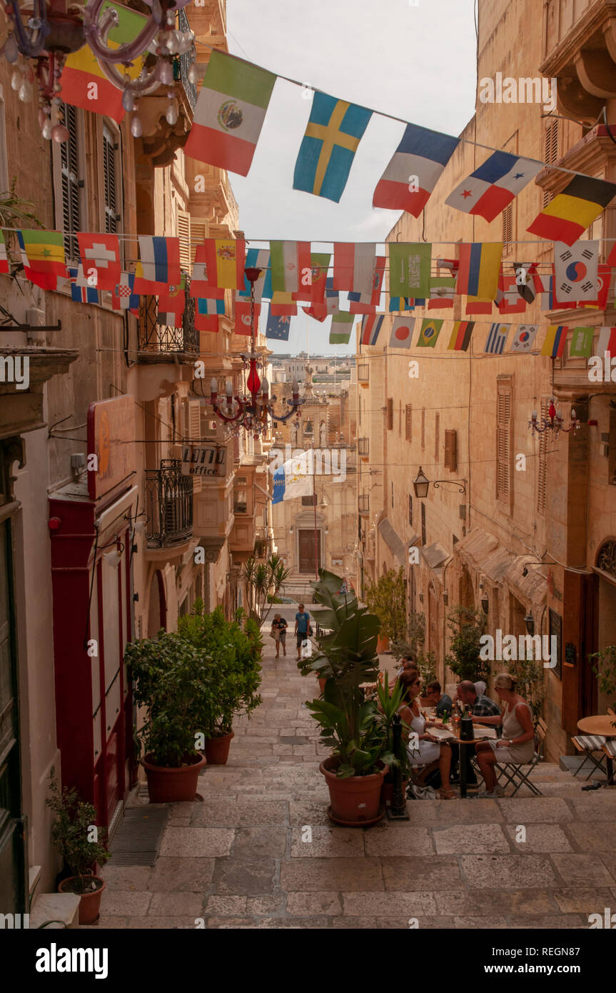 View down the steps of St. Lucia Street in Valletta, Malta with St. Lucia church at the end of it. Stock Photo