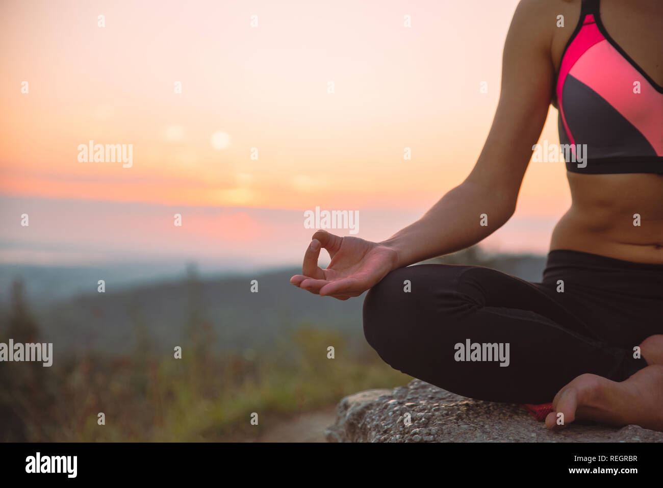 woman do yoga exercises at top of the hill on sunrise Stock Photo - Alamy