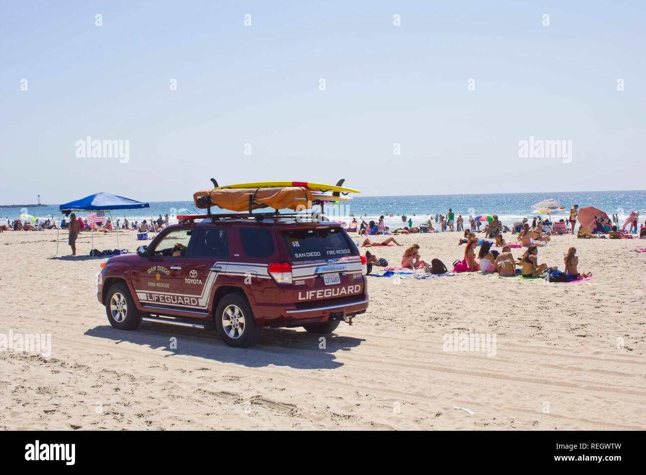 SAN DIEGO, USA - AUGUST 22 2013: Lifeguard vehicle on Mission Bay Beach with people in San Diego, California Stock Photo