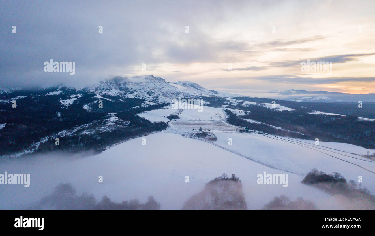 Aerial view of snow capped mountains during sunrise Stock Photo - Alamy