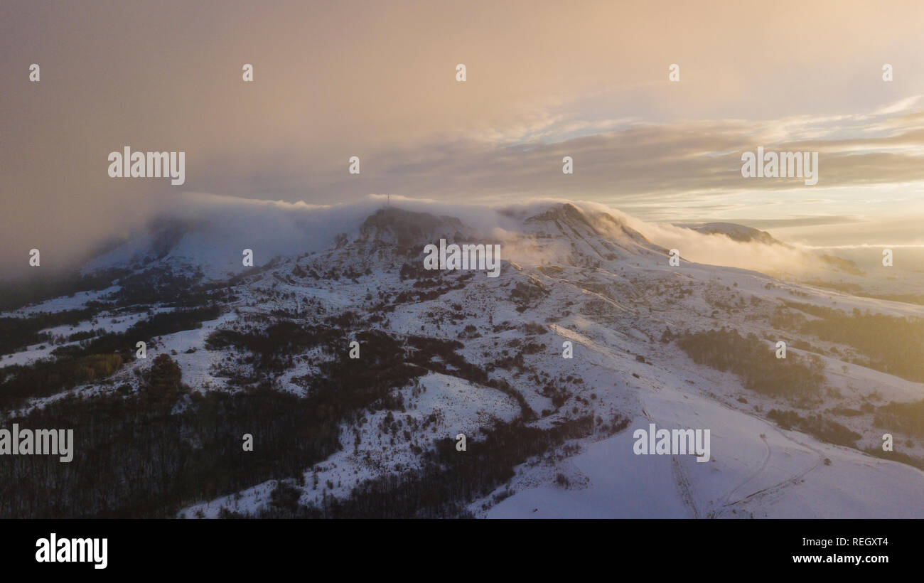 Aerial view of snow capped mountains during sunset Stock Photo - Alamy