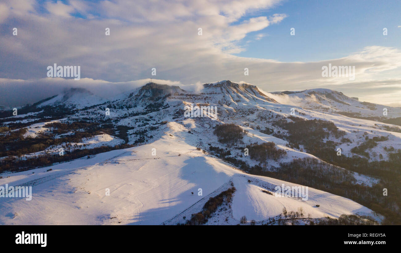Aerial view of snow capped mountains during sunset Stock Photo - Alamy