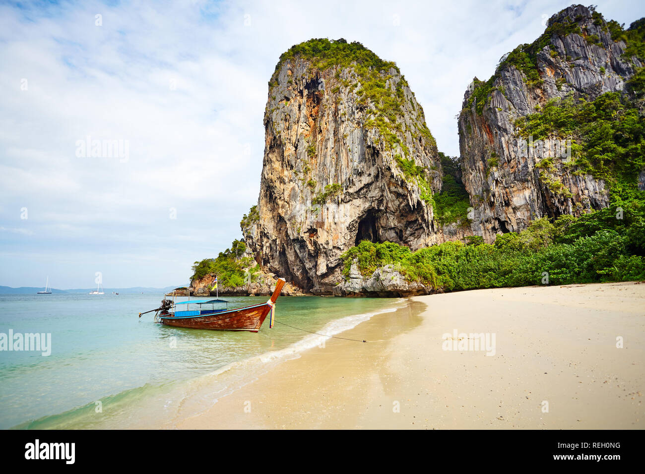 Long tail boat moored by a tropical island, Railay Beach, Thailand. Stock Photo