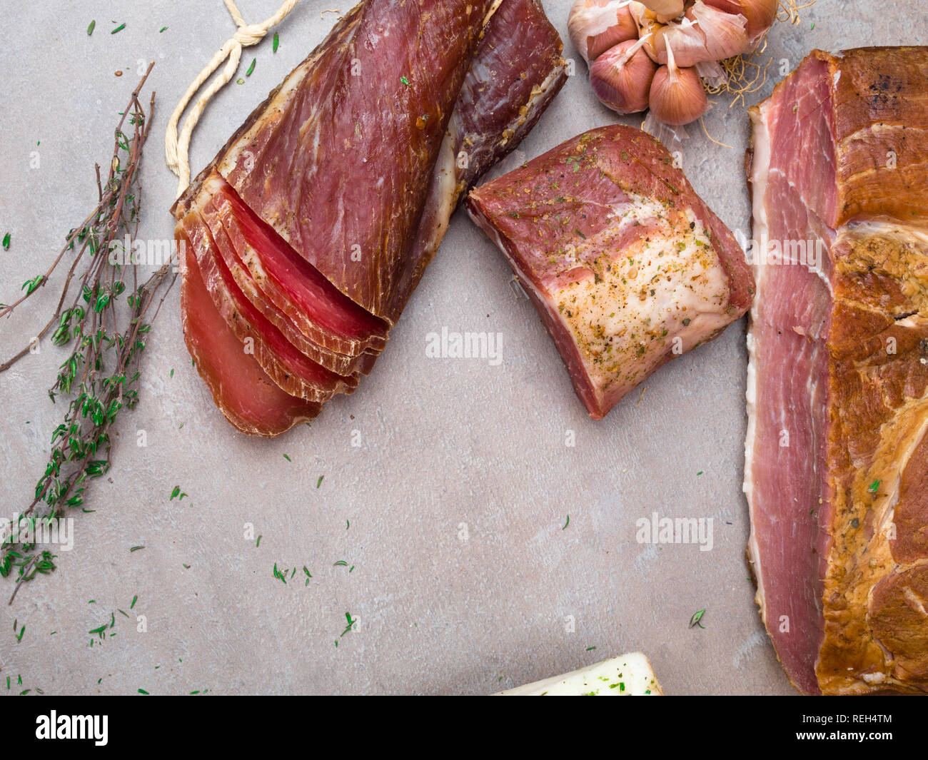 group of smoked Ham, jerky, salted biltong meat, with some garlic and