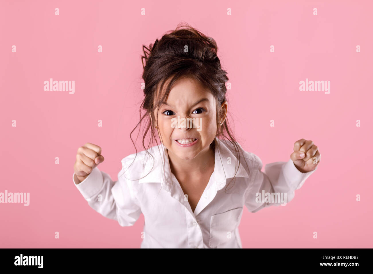 angry little child girl in white shirt with hairstyle Stock Photo - Alamy