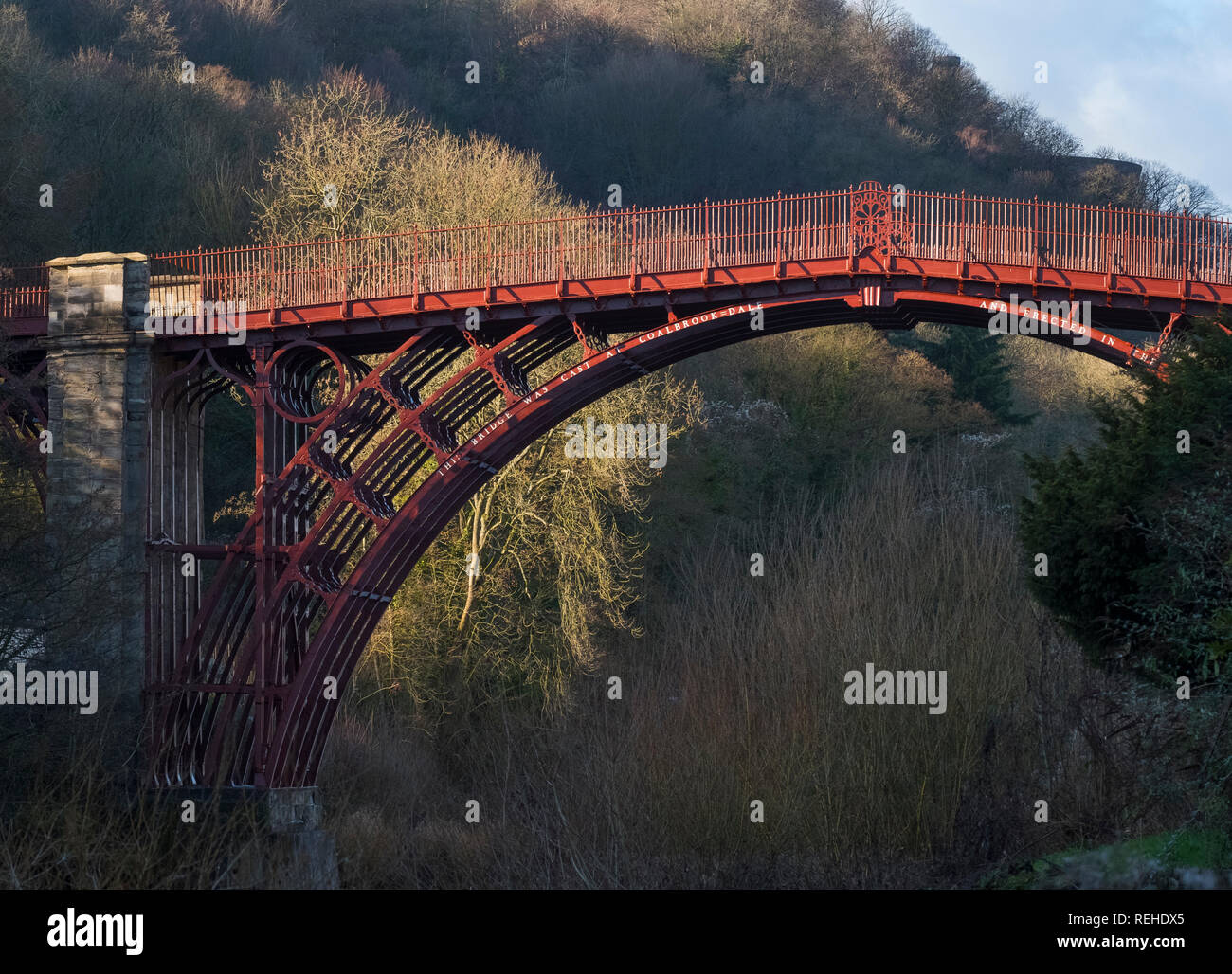 Winter sunlight highlights the red colour of the Iron Bridge over the River Severn at Ironbridge, Shropshire, England, UK Stock Photo