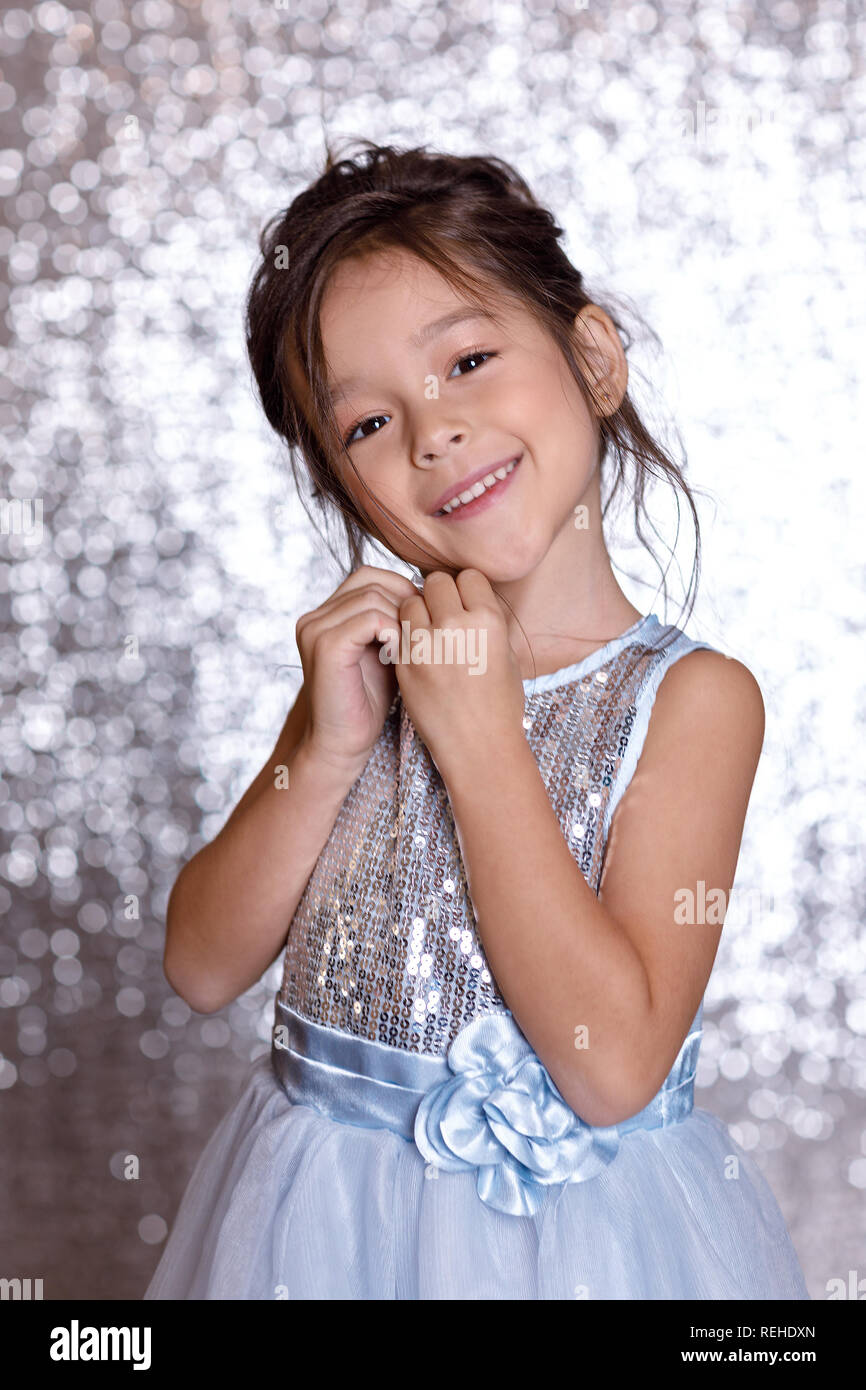 cute smiling little child girl in silver and blue dress Stock Photo - Alamy