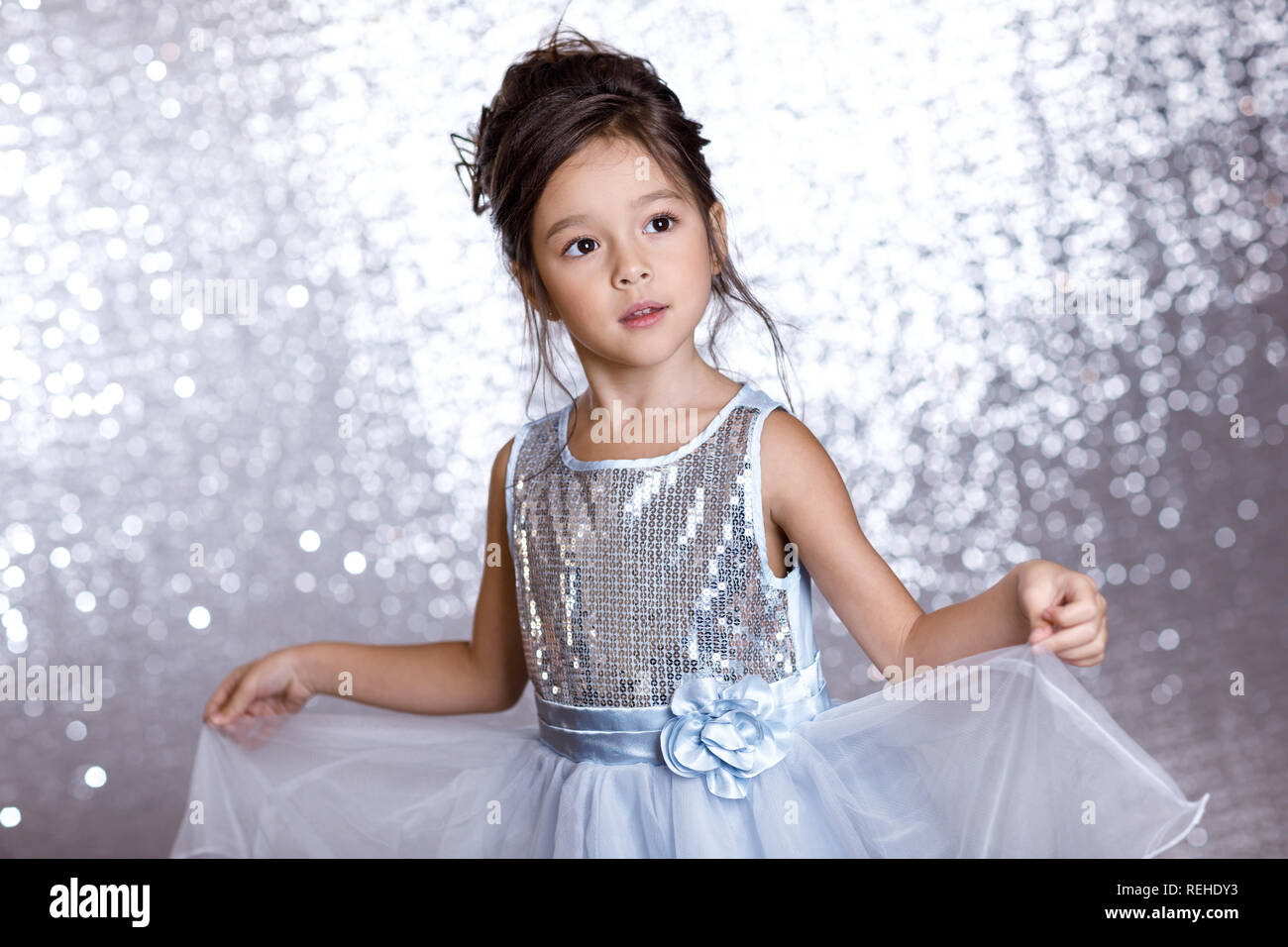 cute smiling little child girl in silver and blue dress Stock Photo - Alamy
