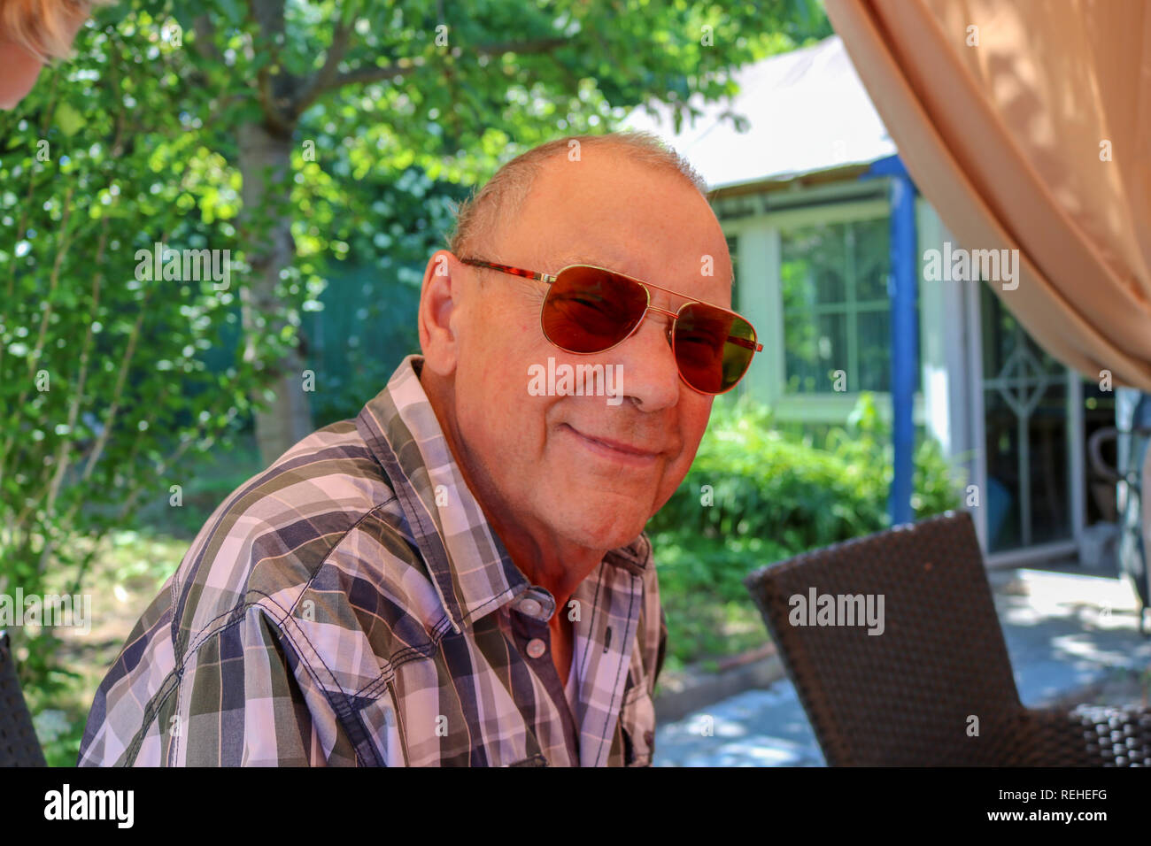 Portrait of smiling senior man with eyeglasses looking at camera Stock Photo