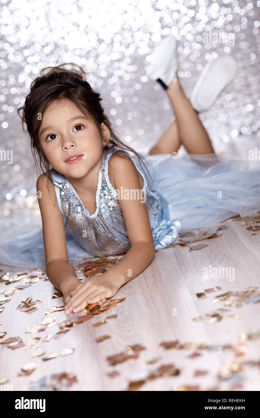 little girl in blue dress sitting on the floor with confetti Stock ...