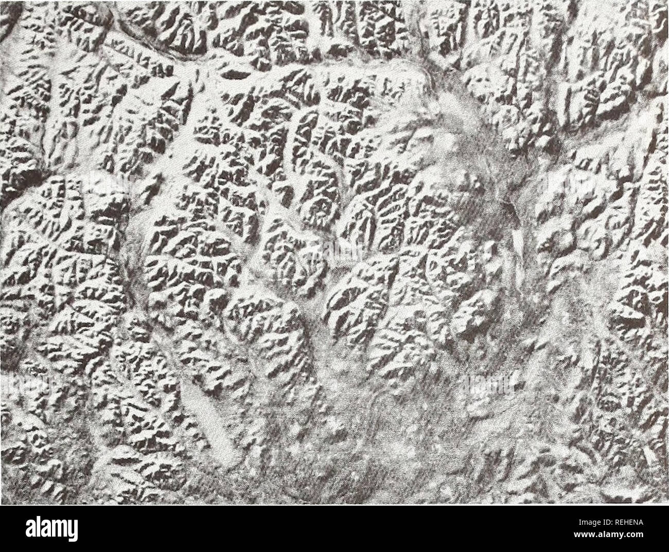 . Collected reprints / Atlantic Oceanographic and Meteorological Laboratories [and] Pacific Oceanographic Laboratories. Oceanography Periodicals.. Fig. 1 Labynkyr ring, 65 km across. This is a possible astrobleme in western Siberia (63°N, 143° E) with the annular geomorphic style of Manicouagan in a maturely dissected plateau region of the Verkoyansk Mountains 2,000 m high. Image is inverted, south to the north, so that shadows fall toward the observer. Scale on all images is 1 cm equals approx. 10 km (ERTS scene #1097-1204).. Please note that these images are extracted from scanned page image Stock Photo