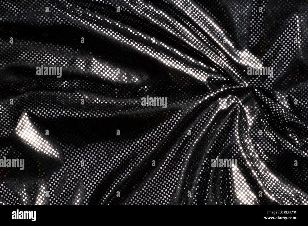 Gray black metalic silver polka dot fabric texture background. Stock Photo