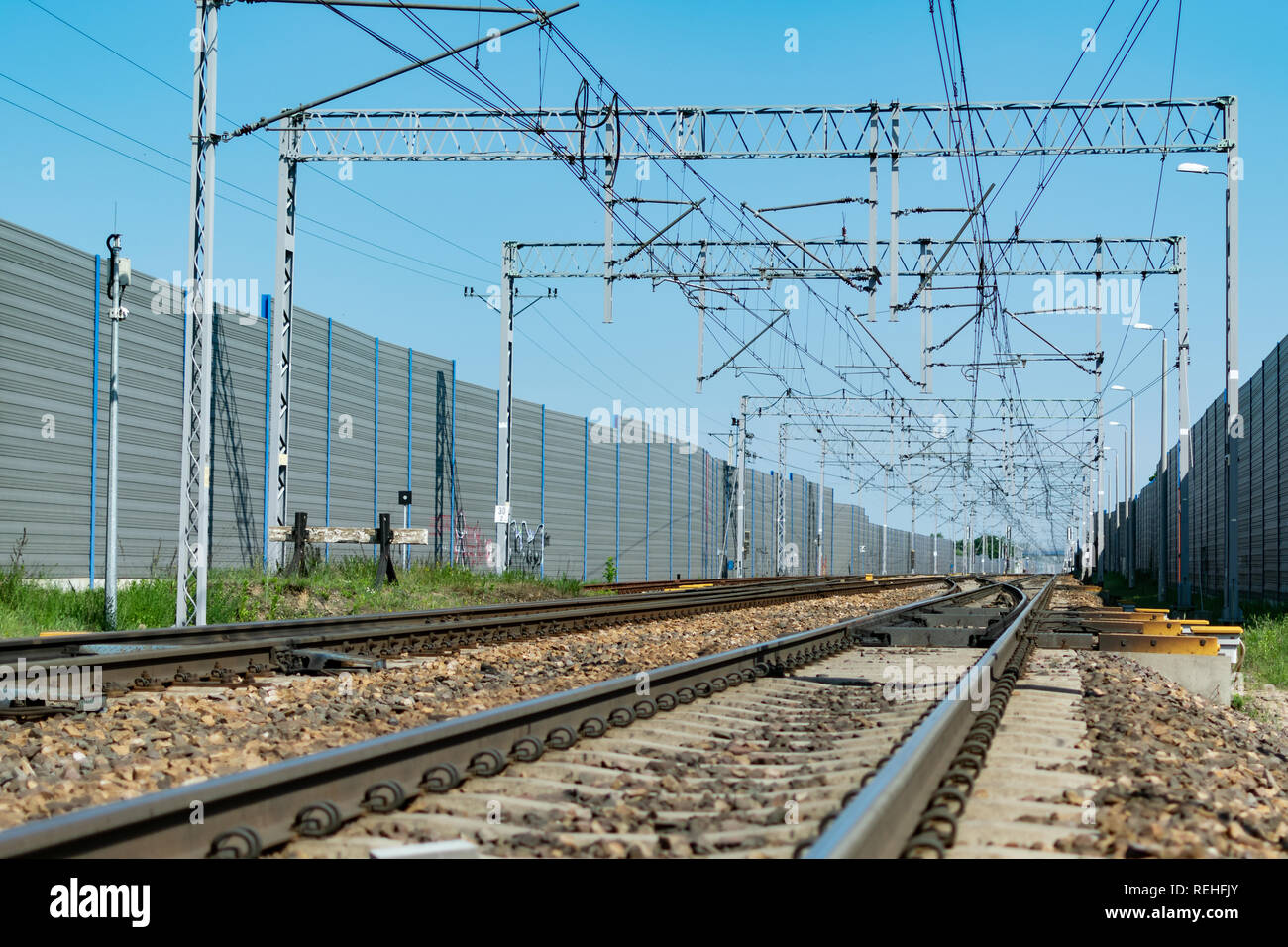 Railway tracks and electric network protected by sound barriers Stock
