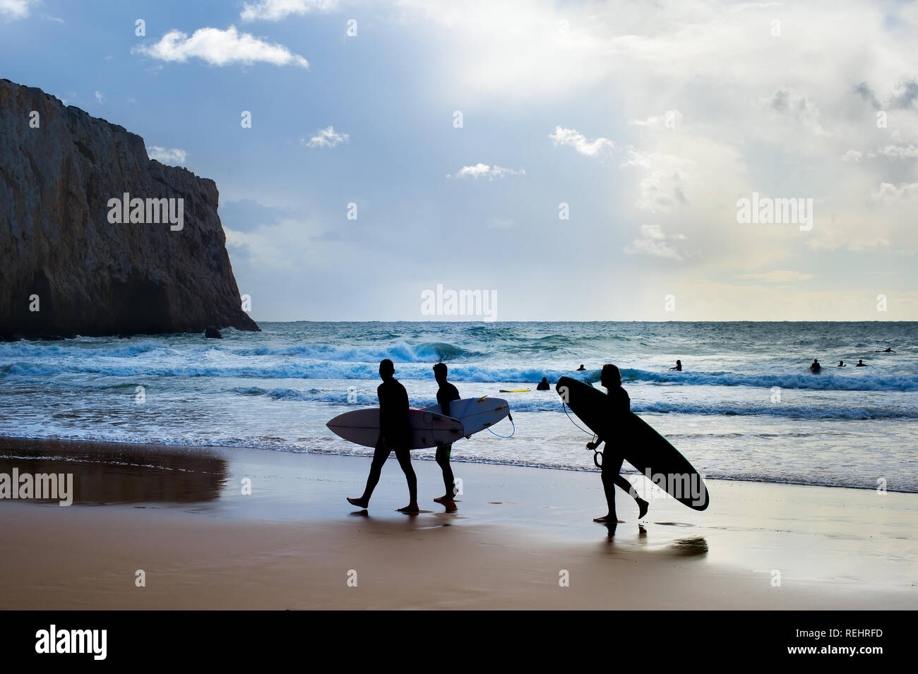Group of surfers with surfboards on the beach. Algarve, Portugal Stock Photo