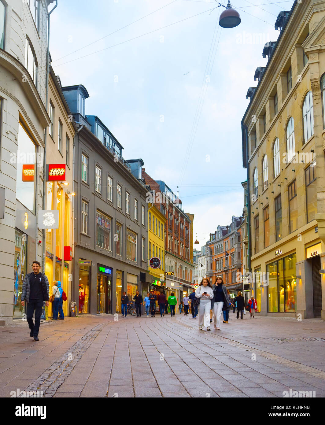 COPENHAGEN, DENMARK - JUNE 16, 2018: People walk by the Stroget street - the main shopping street of Copenhagen. Stock Photo
