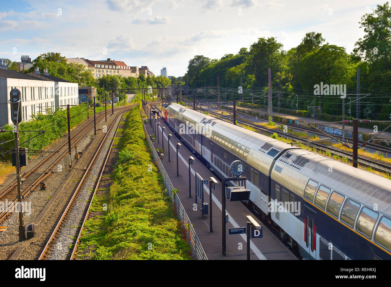 Copenhagen city train arriving to the station platform under bridge ...