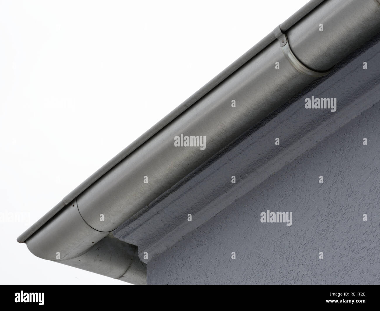 Aluminium rain gutter system on a grey home Stock Photo