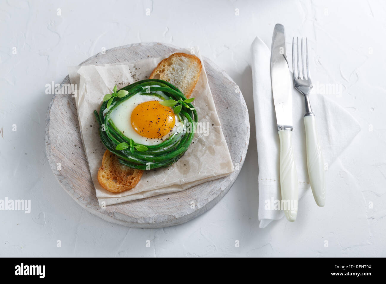 Green beans with sunny side fried egg on toast Stock Photo