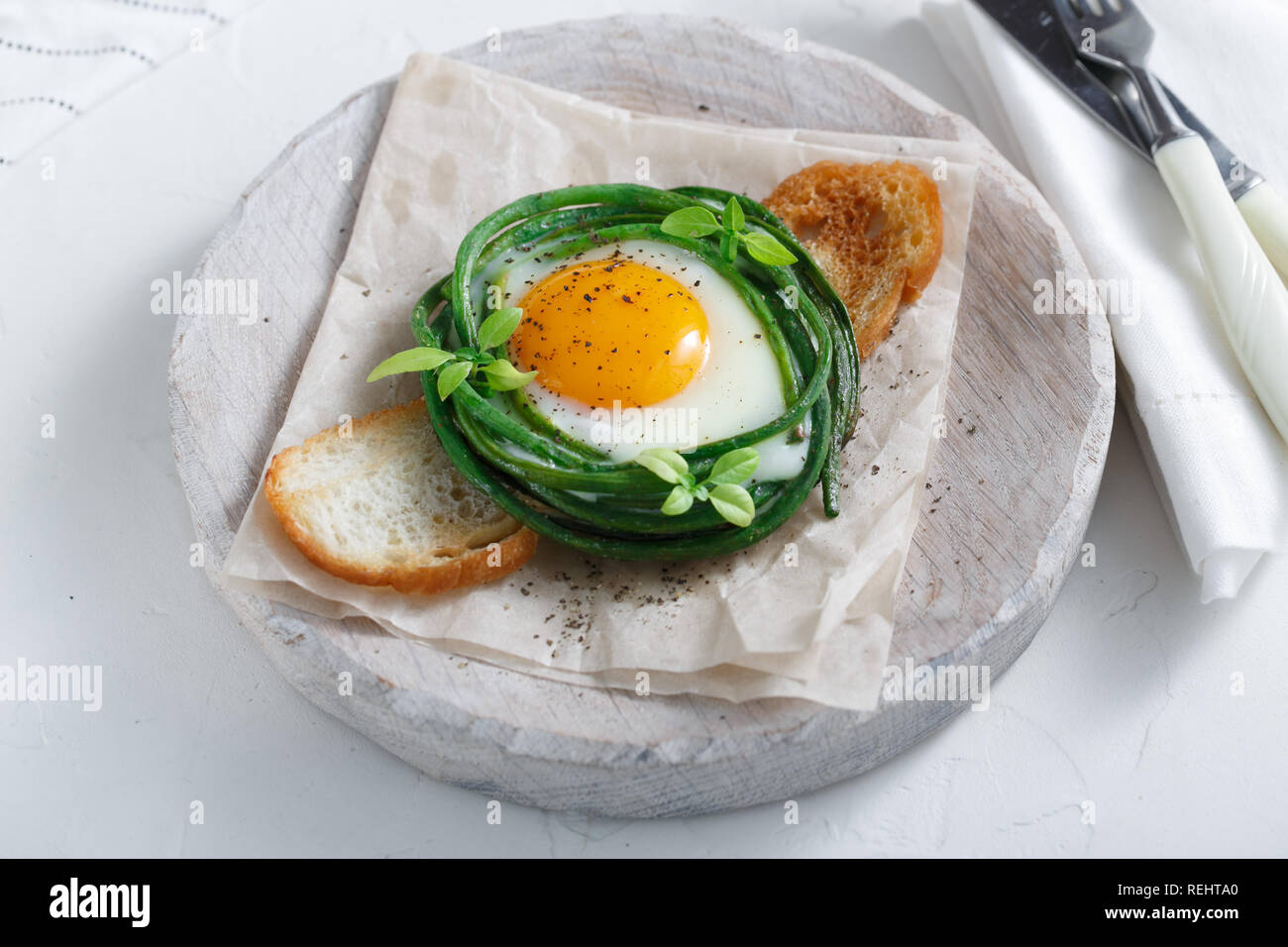 Breakfast with fried egg and green beans Stock Photo