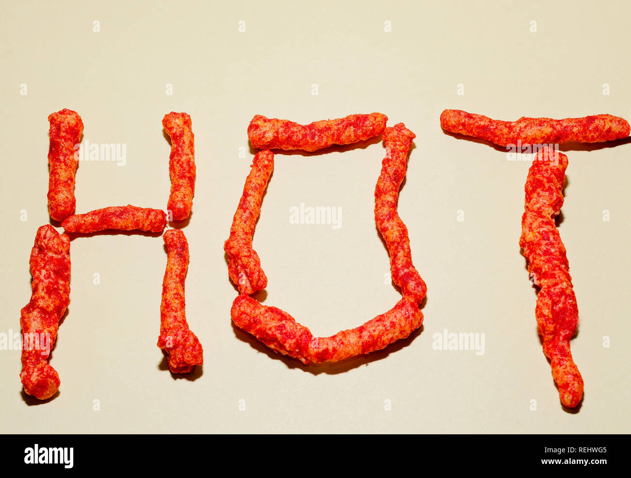 Flamin’ Hot Crunchy Cheetos are arranged to spell the word “hot,” Jan. 3, 2019, in Coden, Alabama. Stock Photo